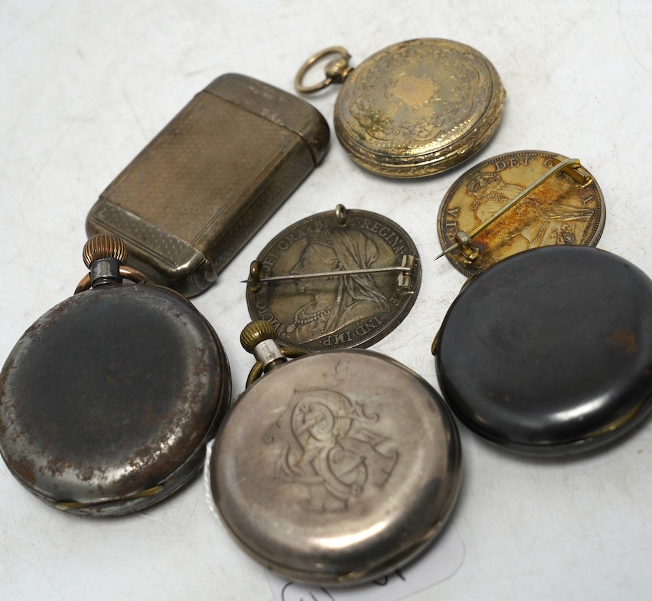 A late Victorian silver double ended vesta case, a silver pocket watch, three other pocket watches including gun metal and two enamelled coin brooches. Condition - poor to fair